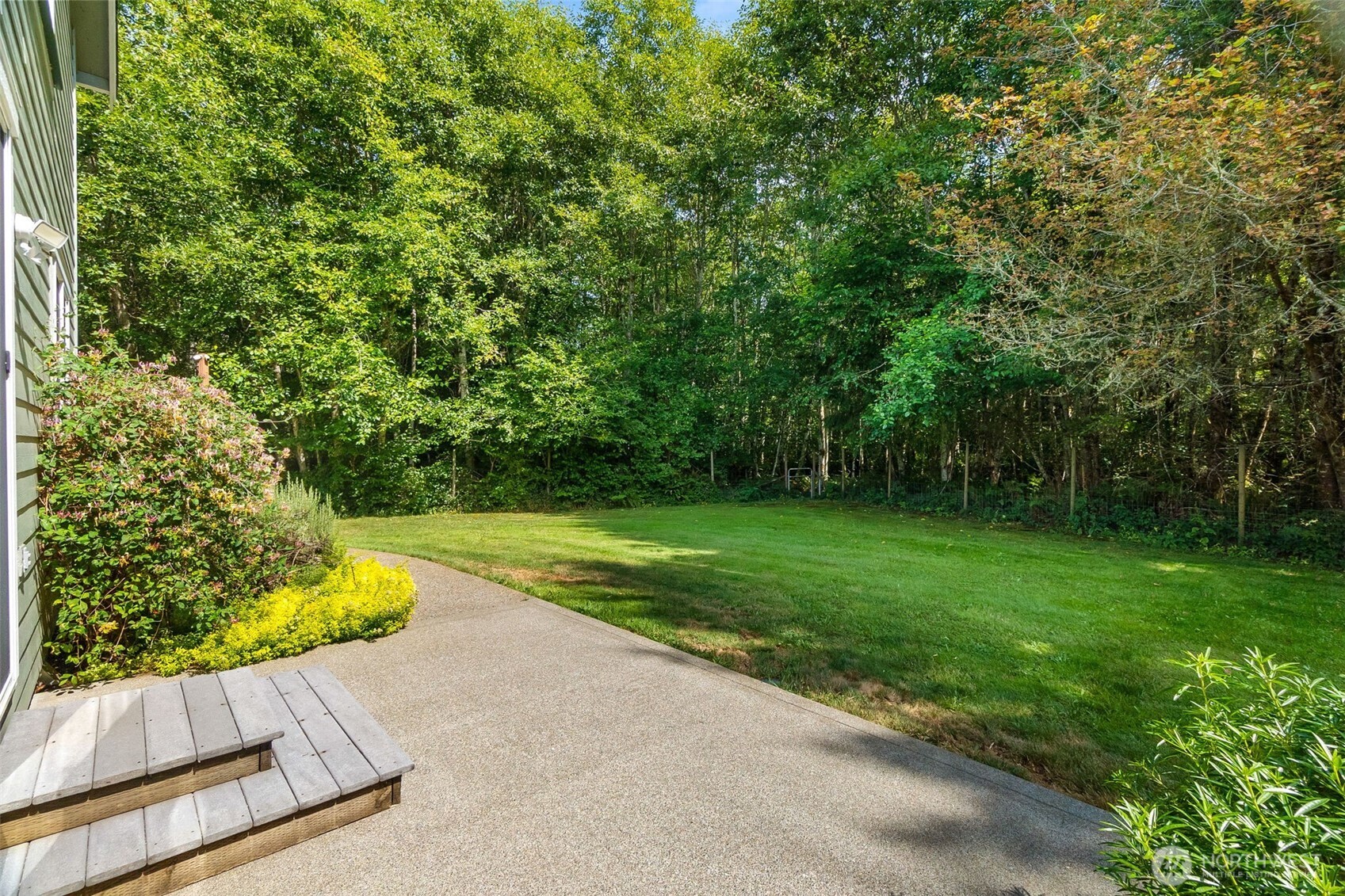 9044 Hunter Point Road Northwest Olympia, WA 98502 - Photo 29 of 40 a view of yard with swimming pool and trees in the background