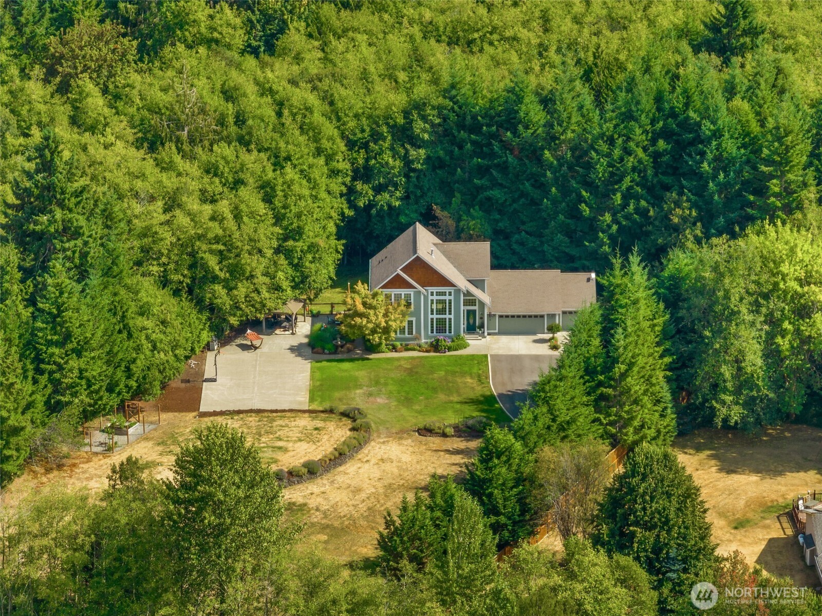9044 Hunter Point Road Northwest Olympia, WA 98502 - Photo 3 of 40 a view of house with outdoor space and garden