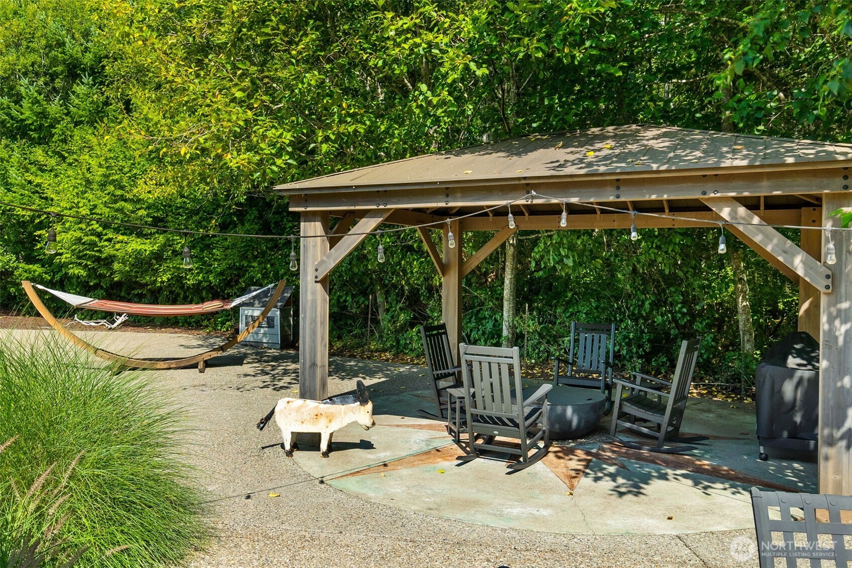 9044 Hunter Point Road Northwest Olympia, WA 98502 - Photo 31 of 40 a view of backyard with deck and outdoor seating