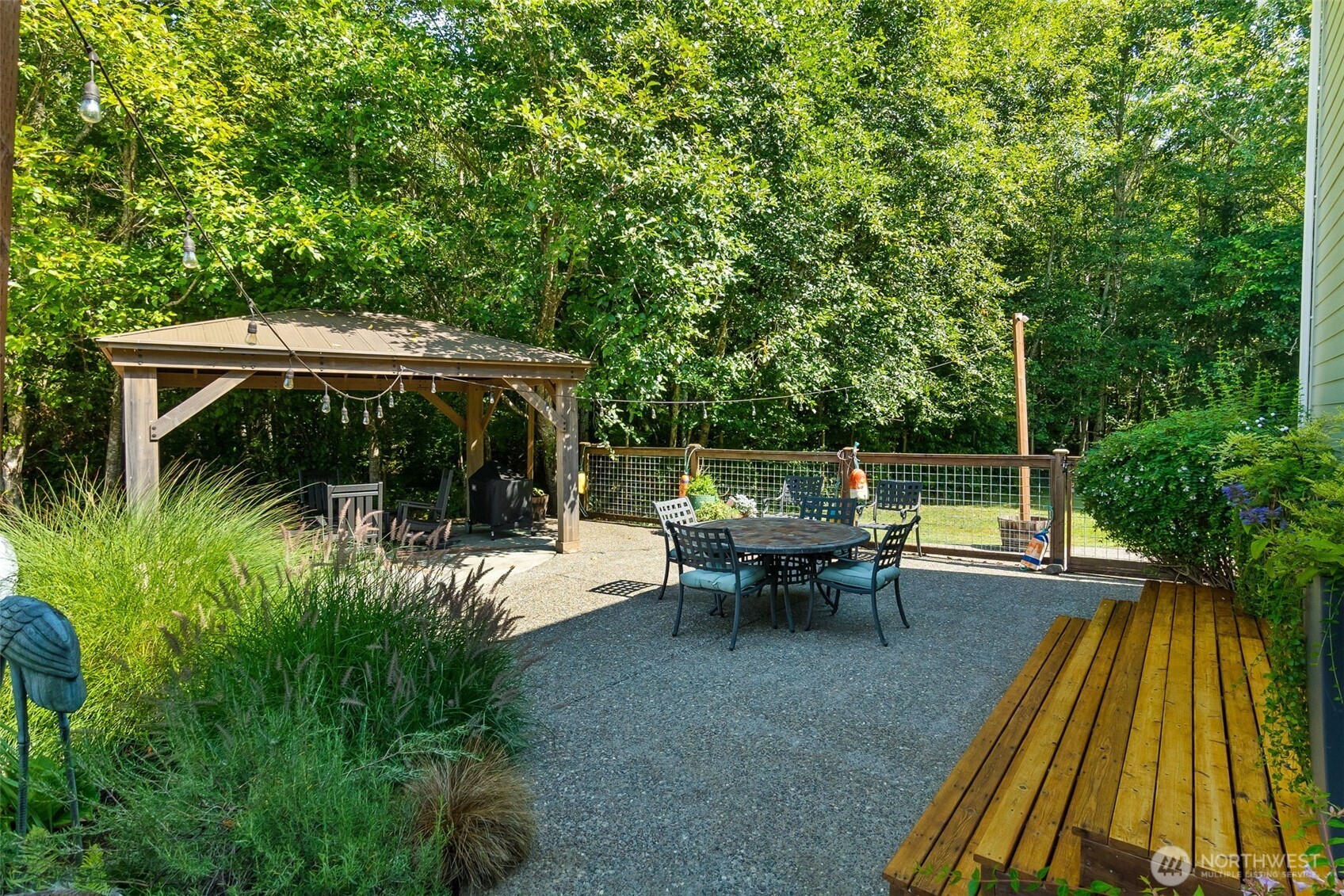 9044 Hunter Point Road Northwest Olympia, WA 98502 - Photo 33 of 40 an outdoor view of a garden with sitting area