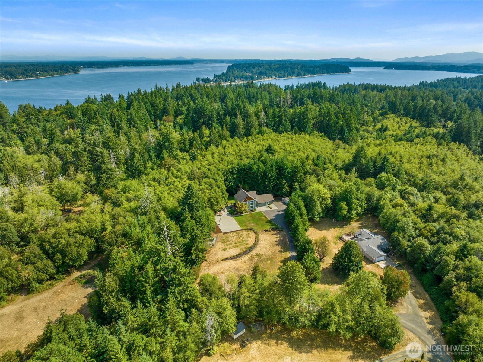9044 Hunter Point Road Northwest Olympia, WA 98502 - Photo 36 of 40 a view of a lake with a yard