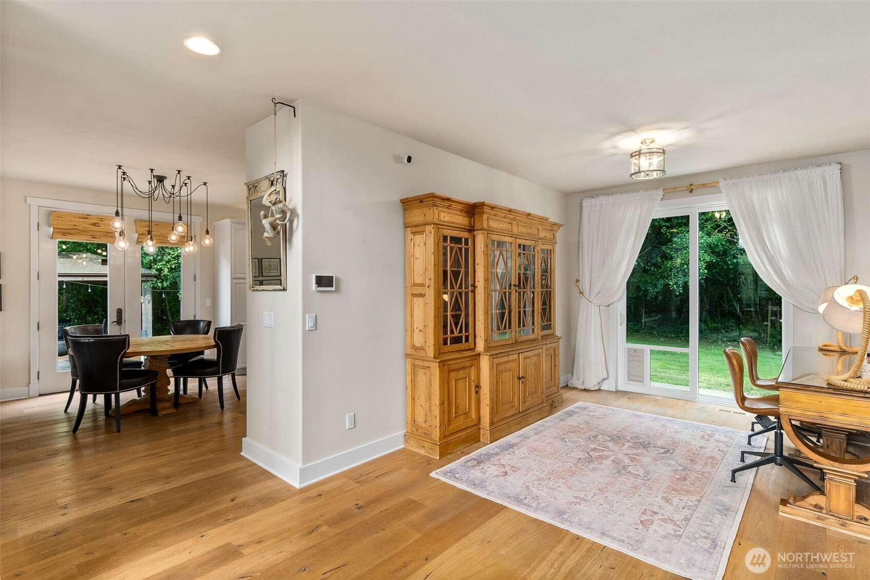 9044 Hunter Point Road Northwest Olympia, WA 98502 - Photo 8 of 40 a view of a livingroom with furniture wooden floor and garden view