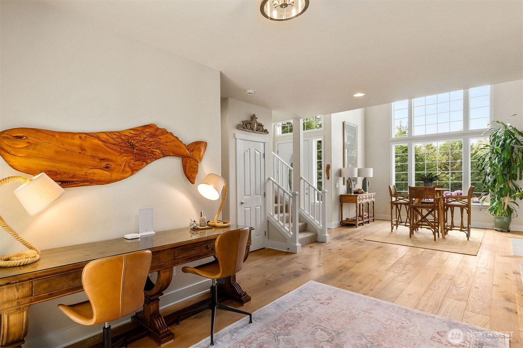 9044 Hunter Point Road Northwest Olympia, WA 98502 - Photo 9 of 40 a dining room with furniture and a floor to ceiling window