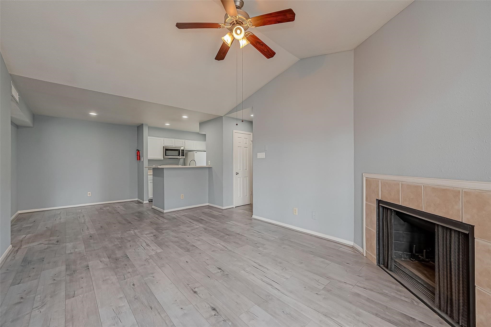 14600 Fonmeadow Drive, Unit 107 Houston, TX 77035 - Photo 12 of 27 an empty room with windows and fireplace