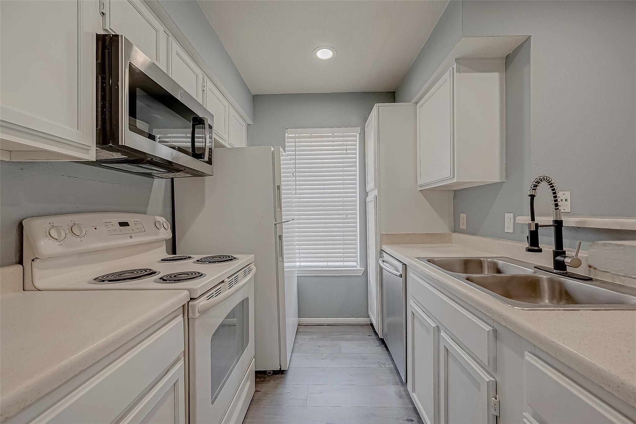 14600 Fonmeadow Drive, Unit 107 Houston, TX 77035 - Photo 16 of 27 a kitchen with stainless steel appliances granite countertop a sink stove and microwave