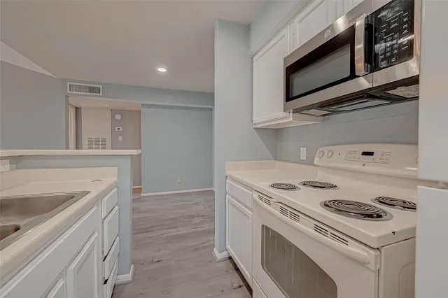 a kitchen with a stove and a microwave