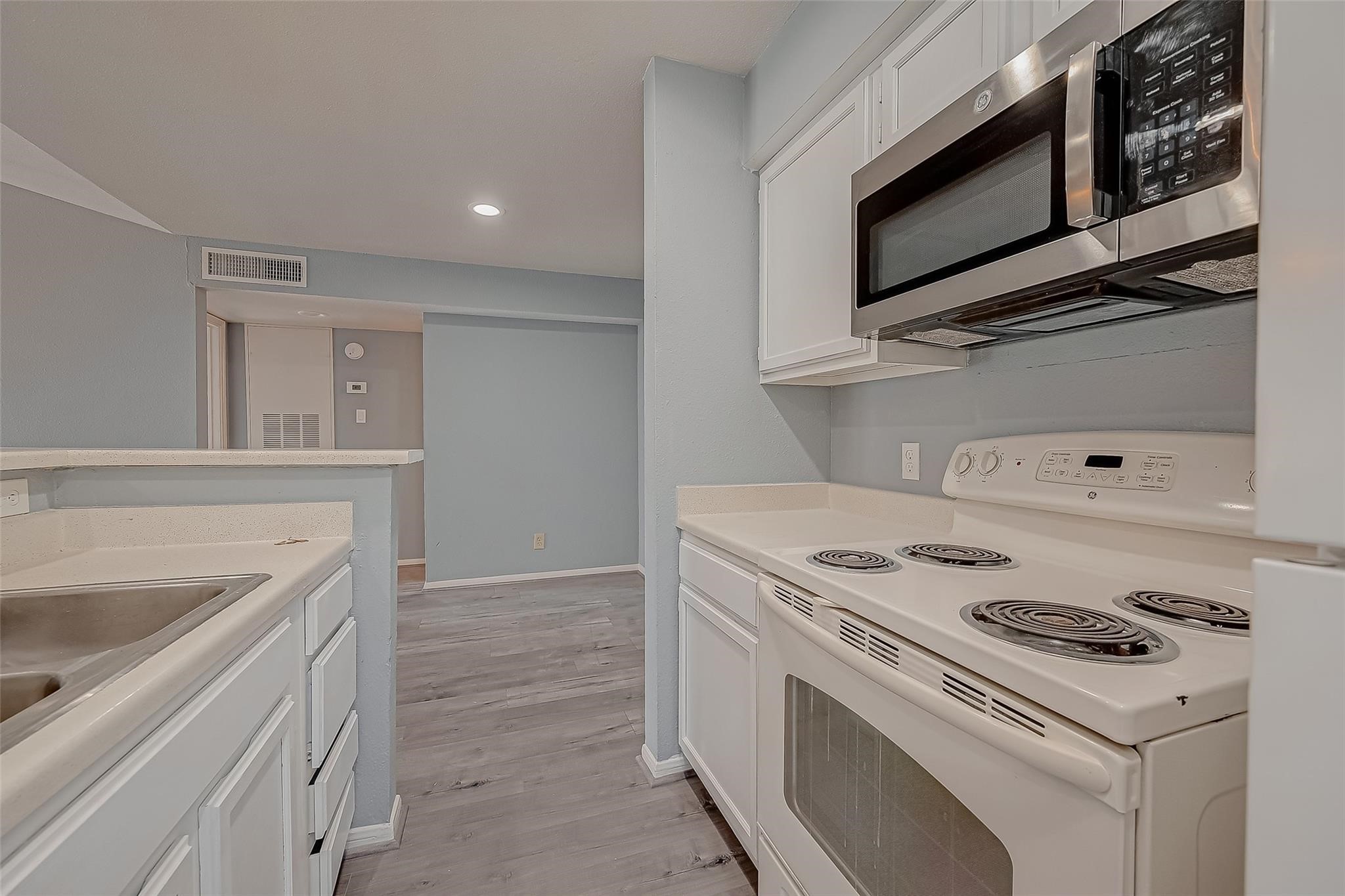 14600 Fonmeadow Drive, Unit 107 Houston, TX 77035 - Photo 18 of 27 a kitchen with a stove and a microwave