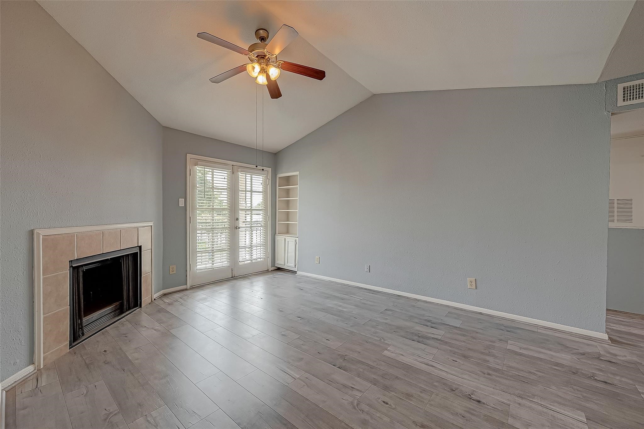 14600 Fonmeadow Drive, Unit 107 Houston, TX 77035 - Photo 5 of 27 a view of an empty room with a fireplace and a window
