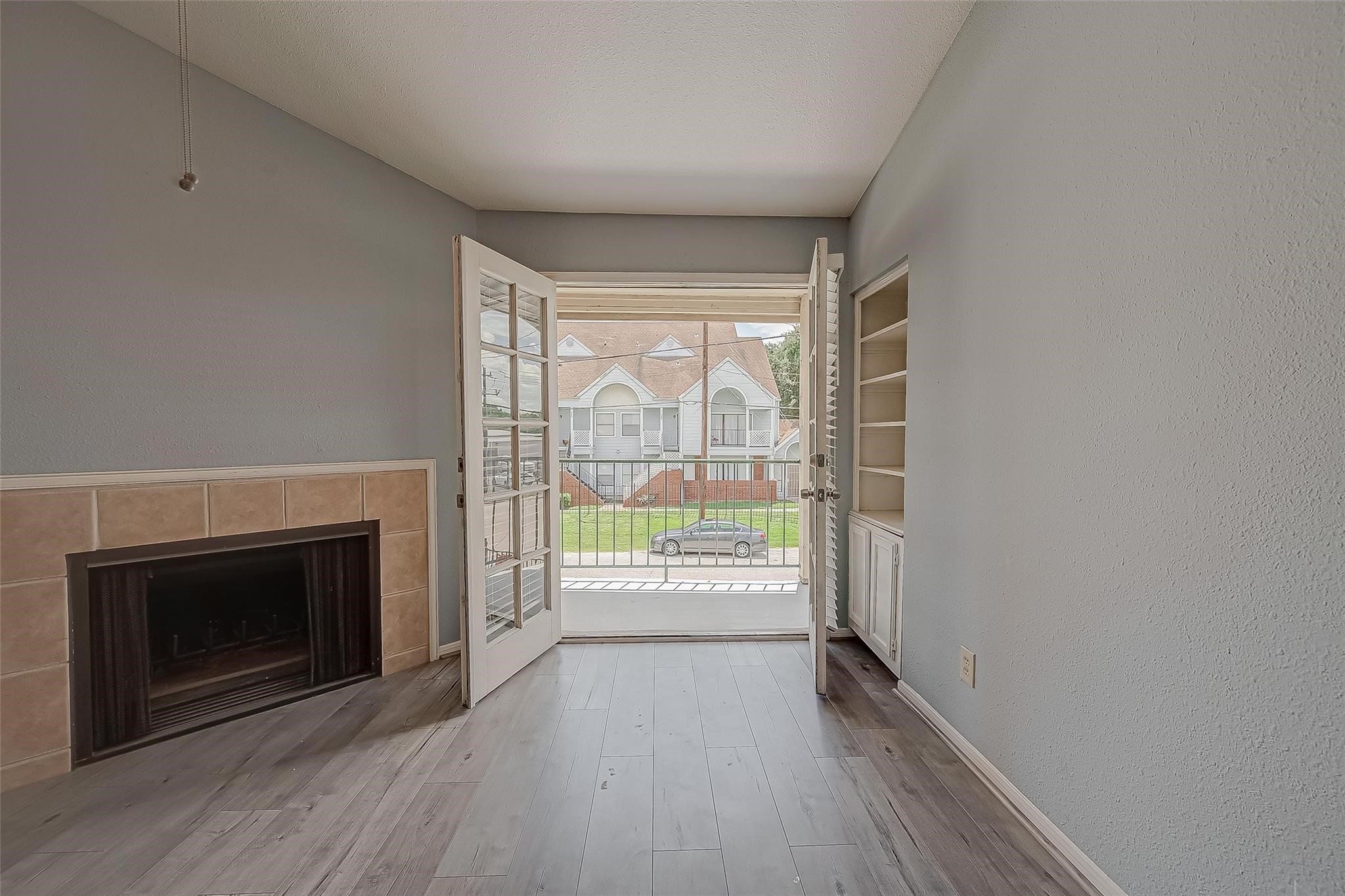 14600 Fonmeadow Drive, Unit 107 Houston, TX 77035 - Photo 8 of 27 a view of an empty room with a fireplace and a window