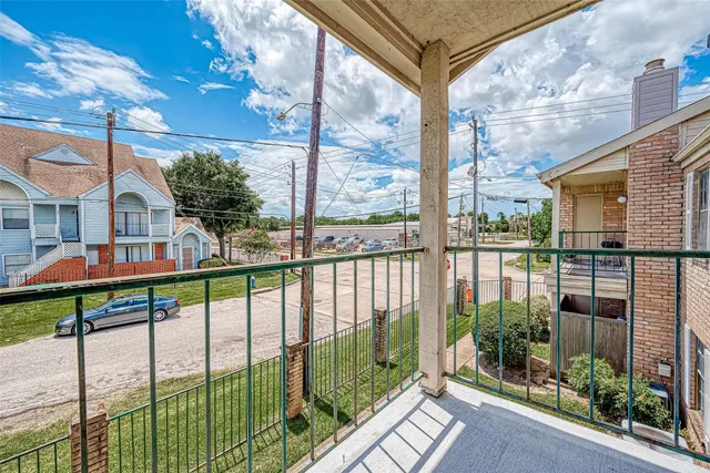 a view of a house with a porch and furniture