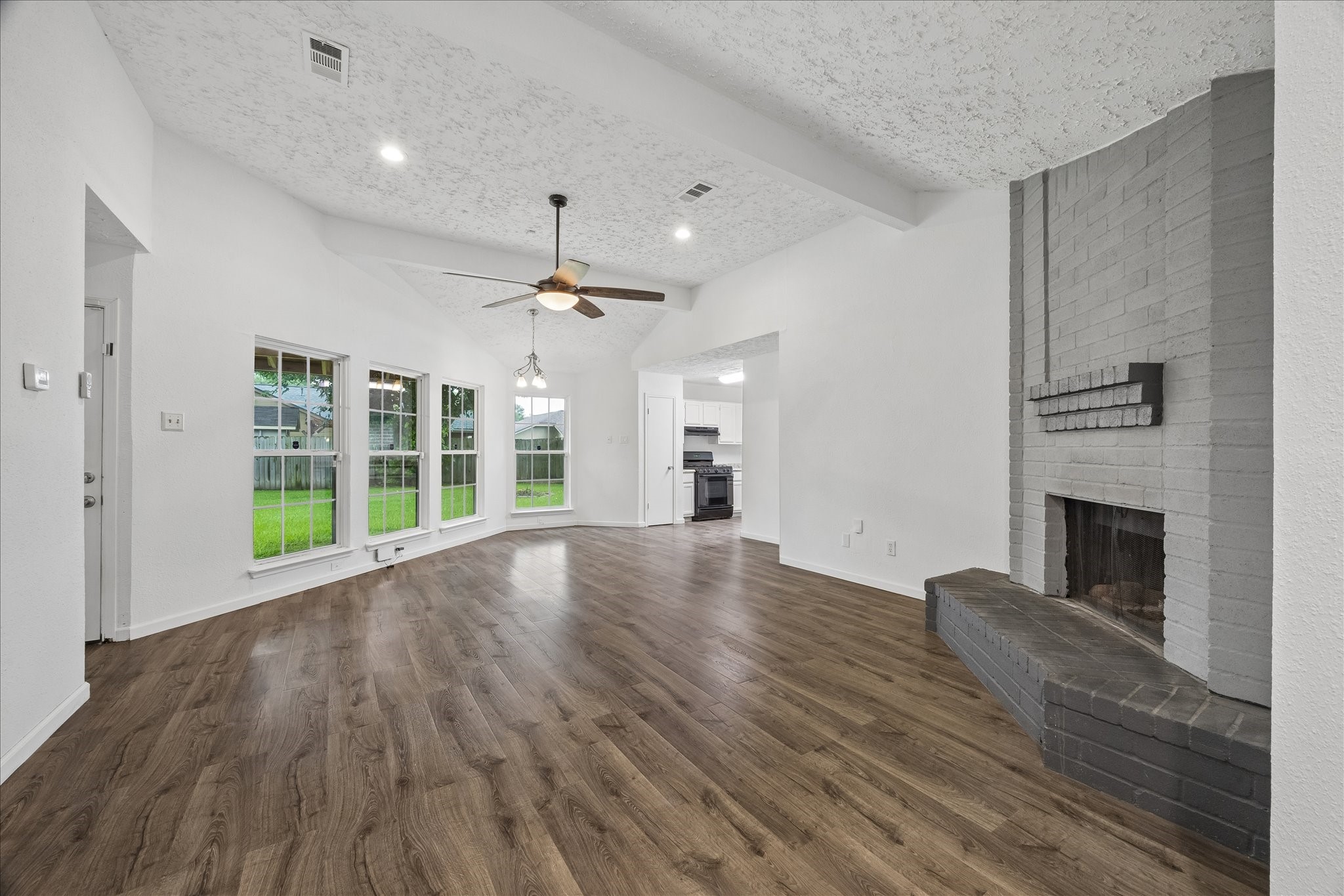 16715 Benchmark Drive Houston, TX 77053 - Photo 7 of 14 a view of empty room with wooden floor and fireplace