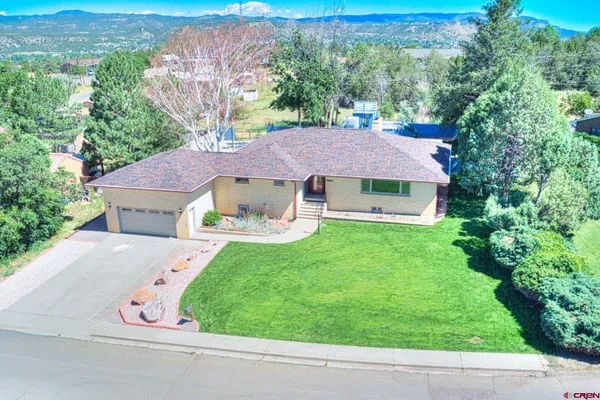 an aerial view of a house with a yard and a garden