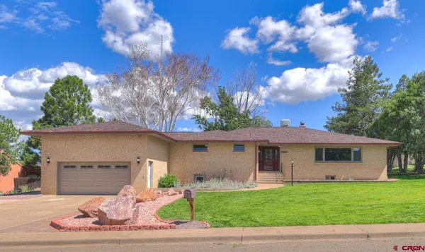 a large kitchen with stainless steel appliances granite countertop a stove and a sink