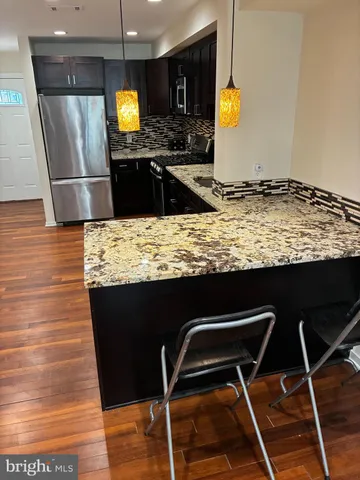 a kitchen with granite countertop wood cabinets and a stove