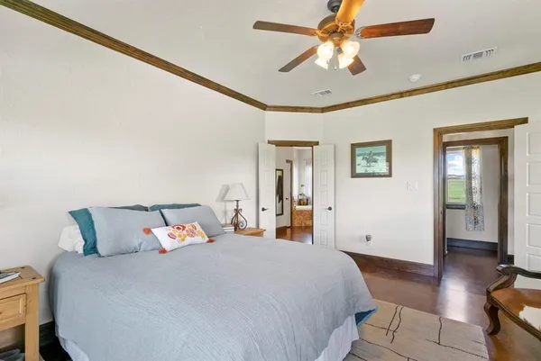 a bedroom with a large bed and a chandelier