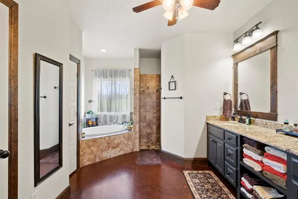 a bathroom with a double vanity sink a mirror and a bathtub
