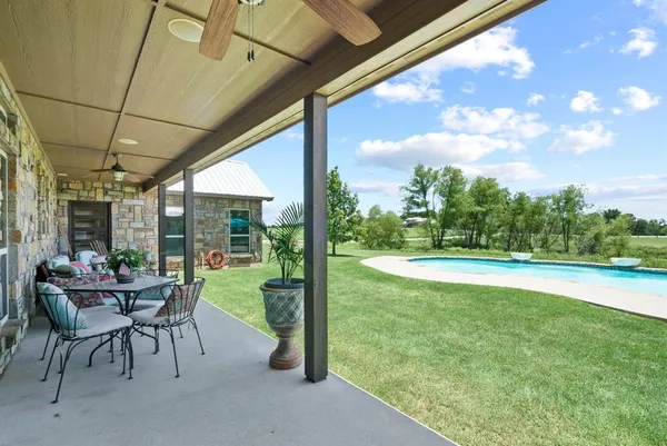 a view of swimming pool with outdoor seating and plants