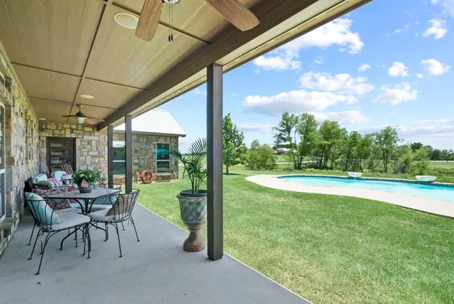 a view of swimming pool with outdoor seating and plants
