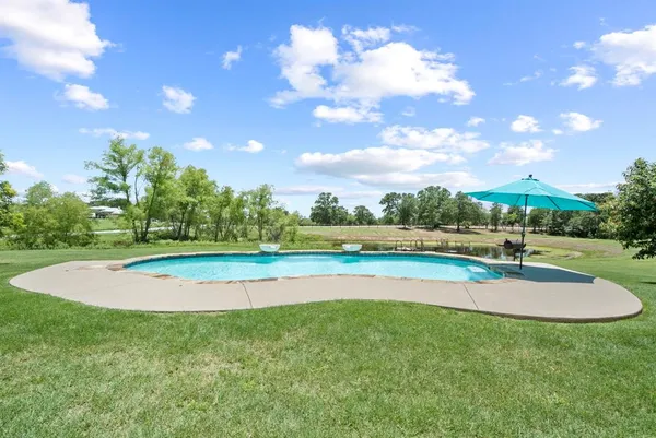 a view of a backyard with large trees