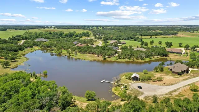 an aerial view of a house with a lake view