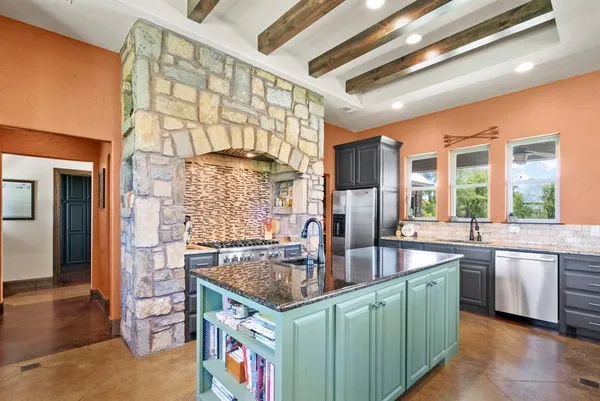 a kitchen with granite countertop a sink and cabinets