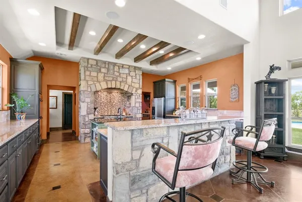 a open kitchen with stainless steel appliances granite countertop a stove and cabinets