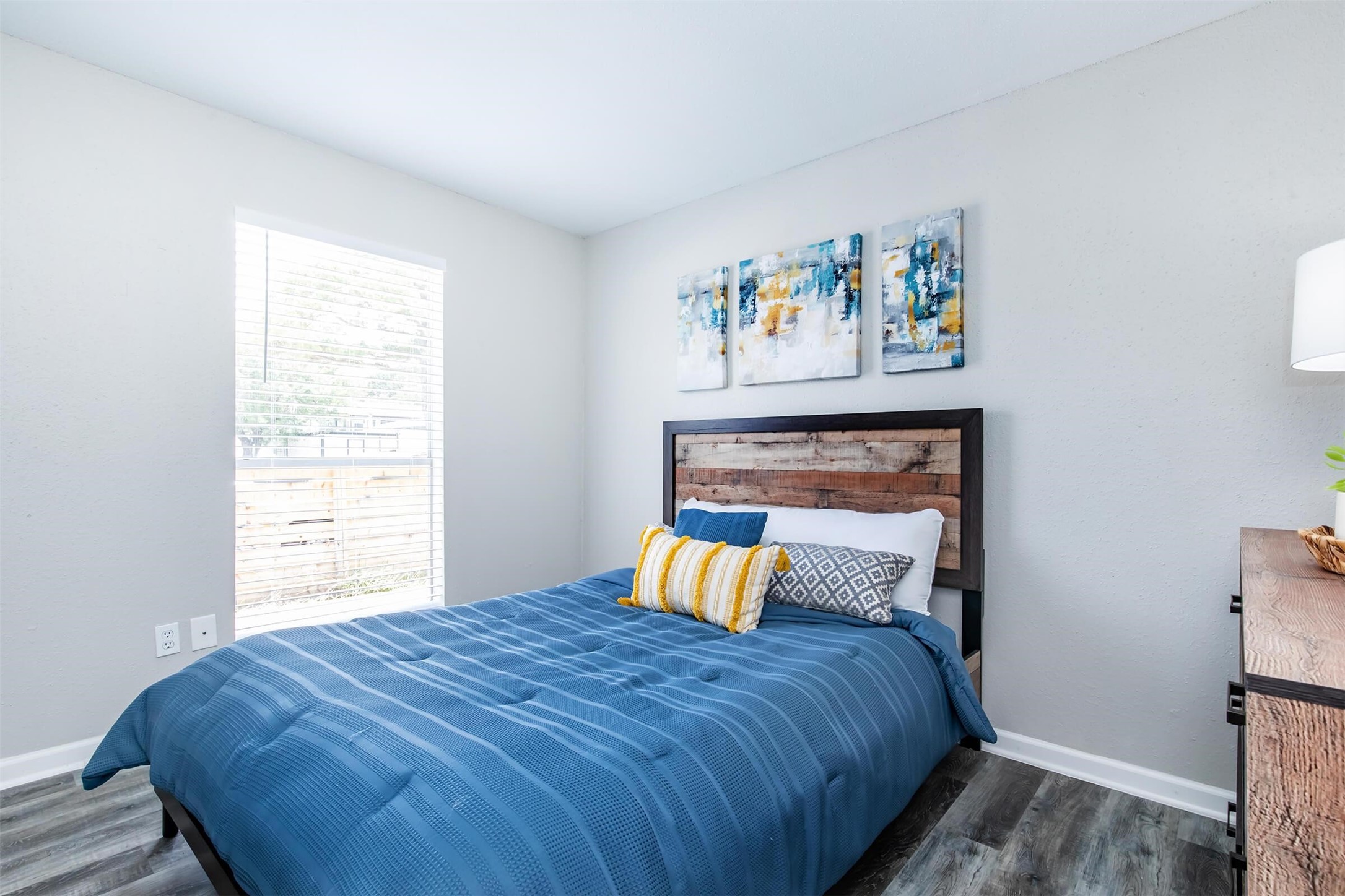 18001 Cypress Trace Road, Unit 102 Houston, TX 77090 - Photo 12 of 32 a bedroom with a bed and painting on the wall