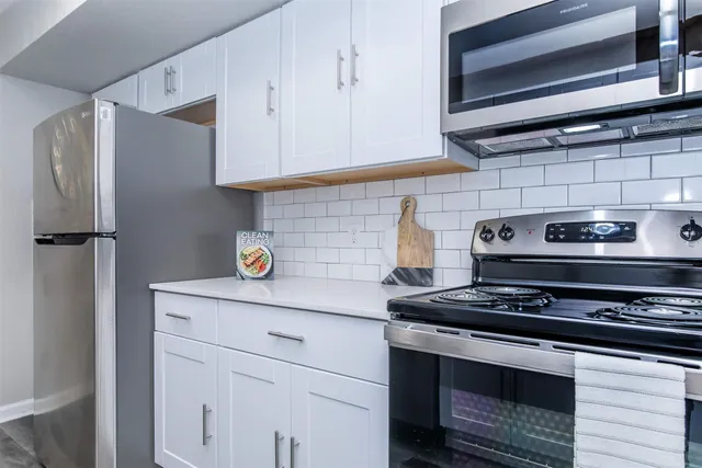 a kitchen with stainless steel appliances granite countertop a stove and a refrigerator
