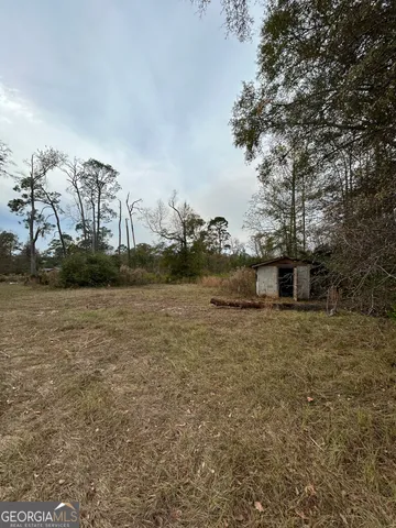 a backyard of a house with lots of green space