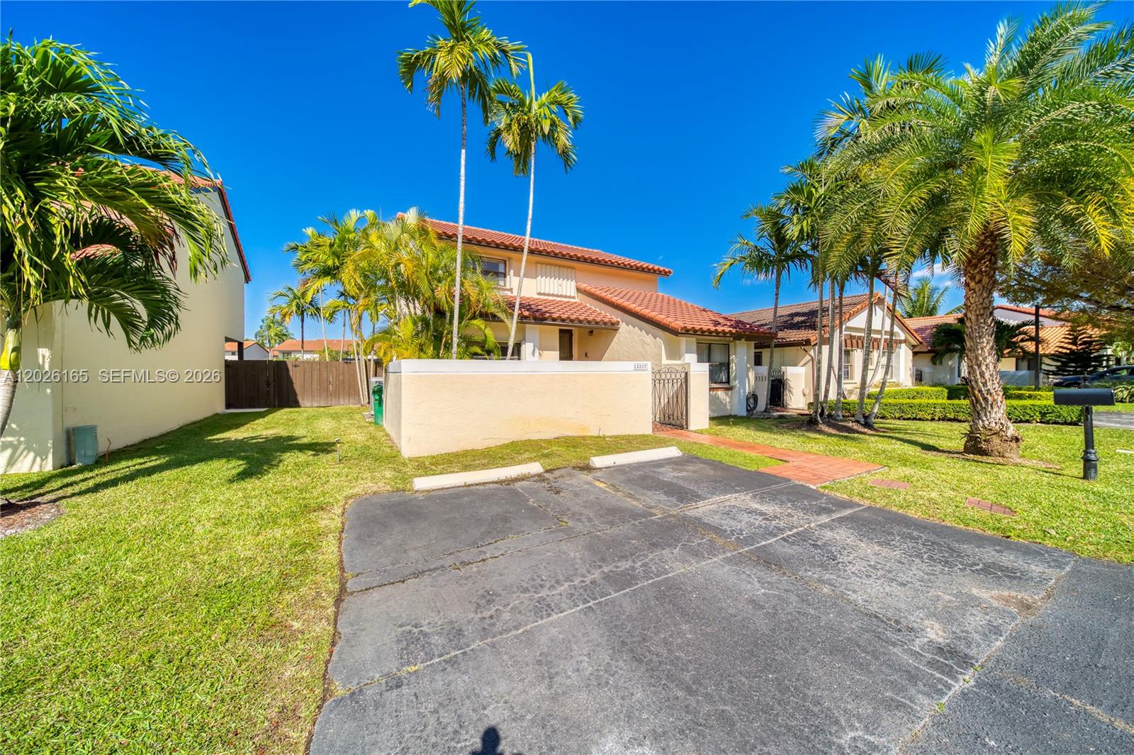 13337 Southwest 64th Lane Miami, FL 33183 - Photo 3 of 36 a blue swimming pool with a yard