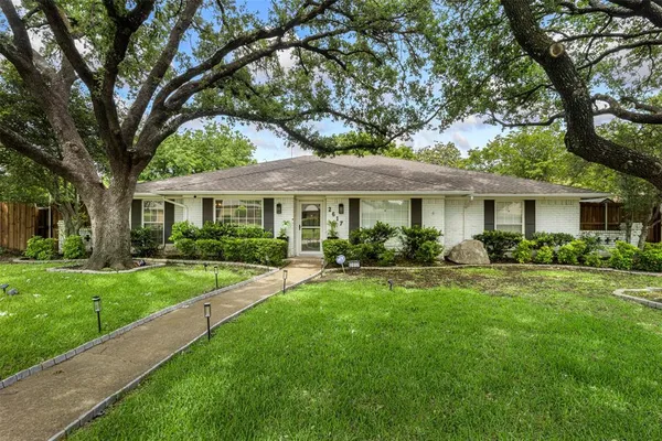 a front view of a house with yard patio and green space
