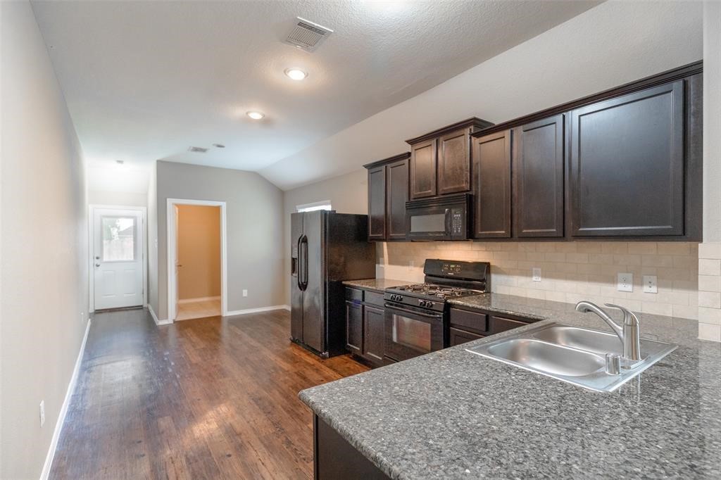 3511 Goldleaf Trail Drive Katy, TX 77449 - Photo 5 of 21 a kitchen with stainless steel appliances granite countertop a sink stove and refrigerator