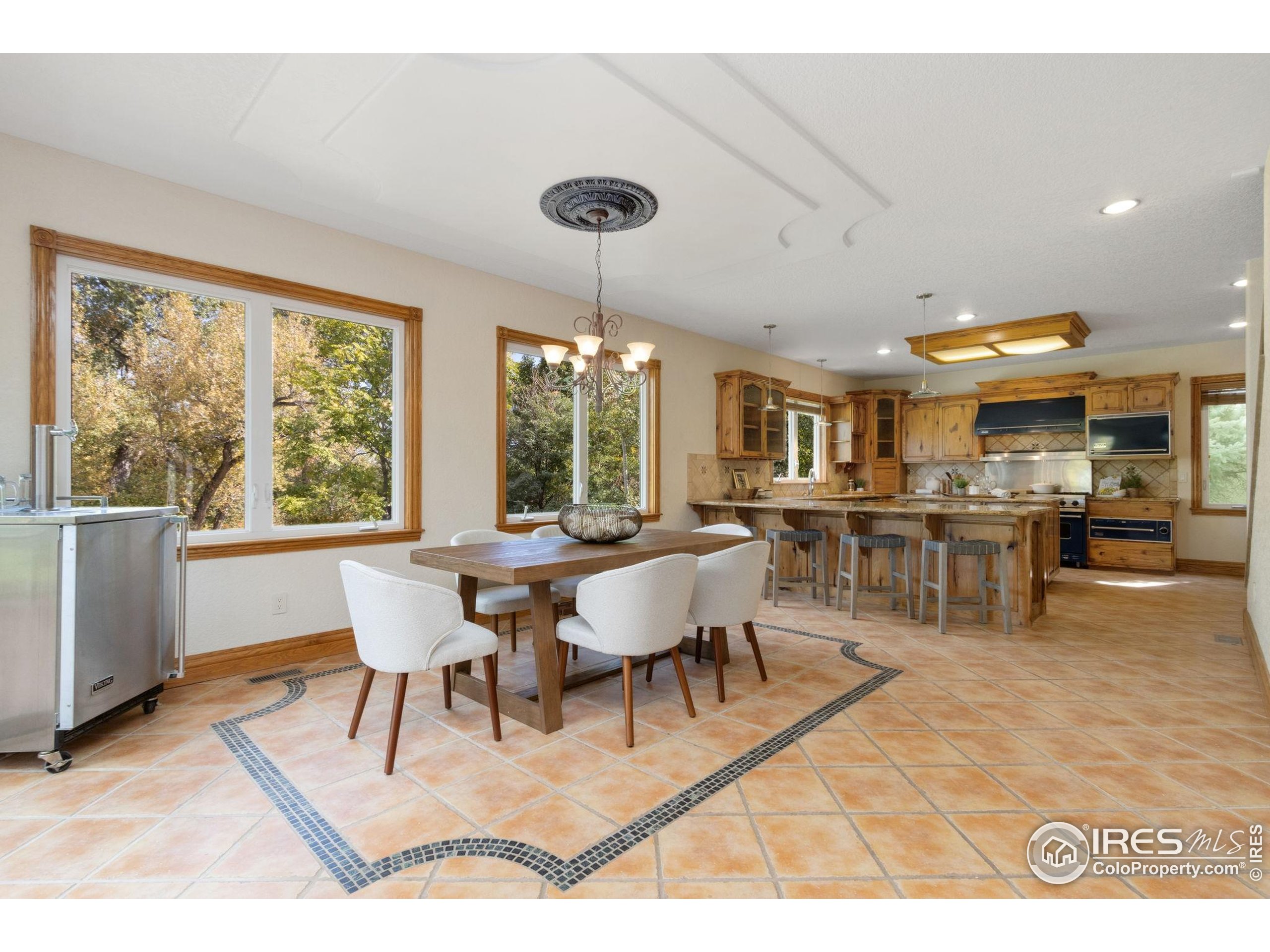 3908 Westfield Court Fort Collins, CO 80526 - Photo 11 of 45 a dining room with wooden floor and large window