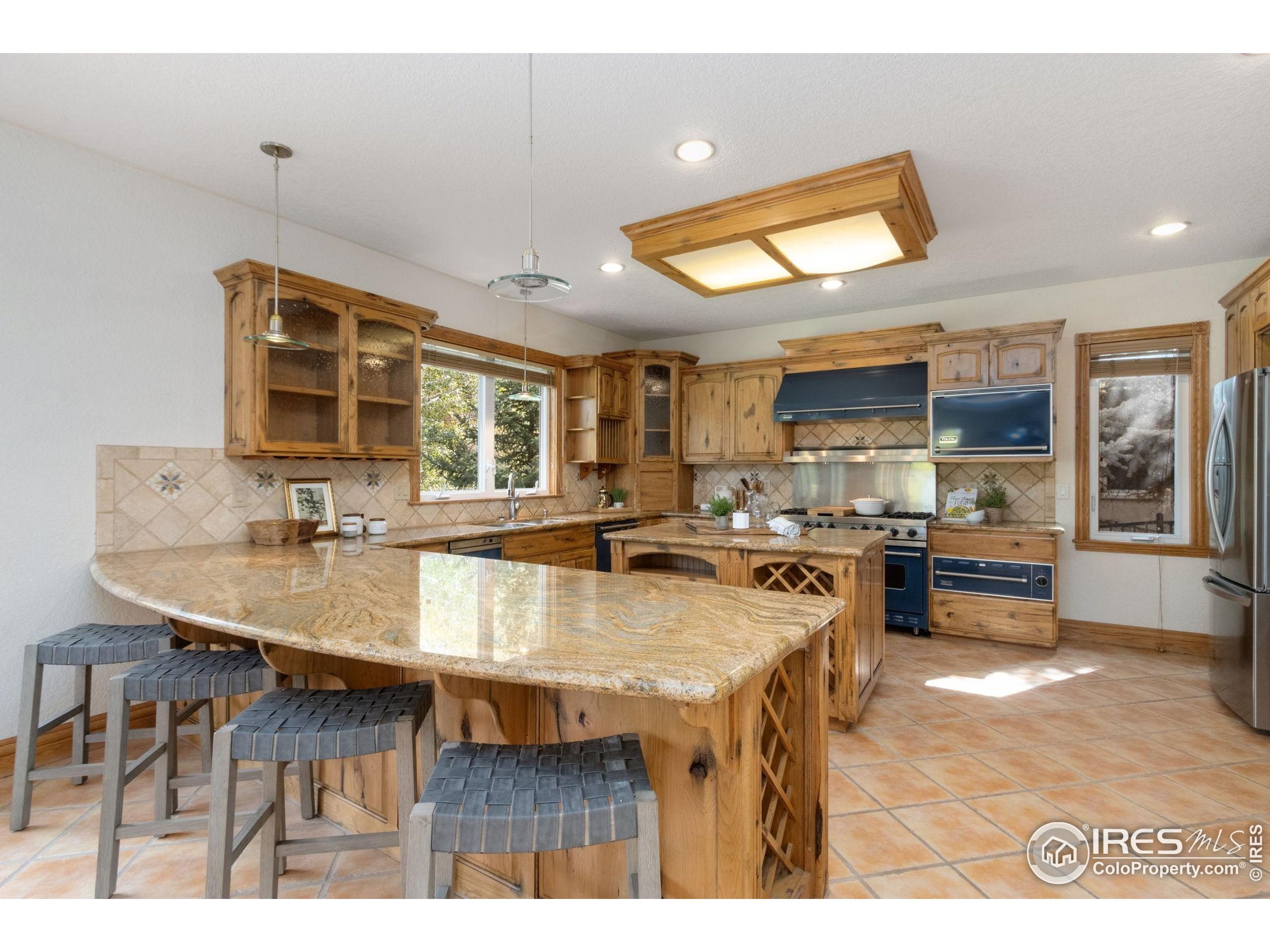 3908 Westfield Court Fort Collins, CO 80526 - Photo 13 of 45 a kitchen with stainless steel appliances granite countertop a sink and counter space