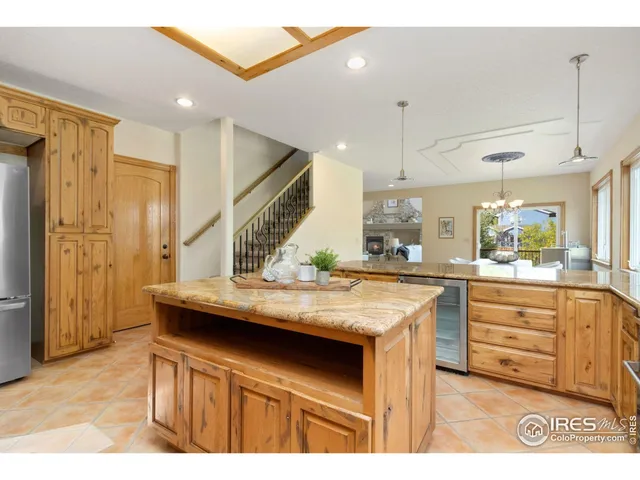 a kitchen with stainless steel appliances kitchen island a chandelier