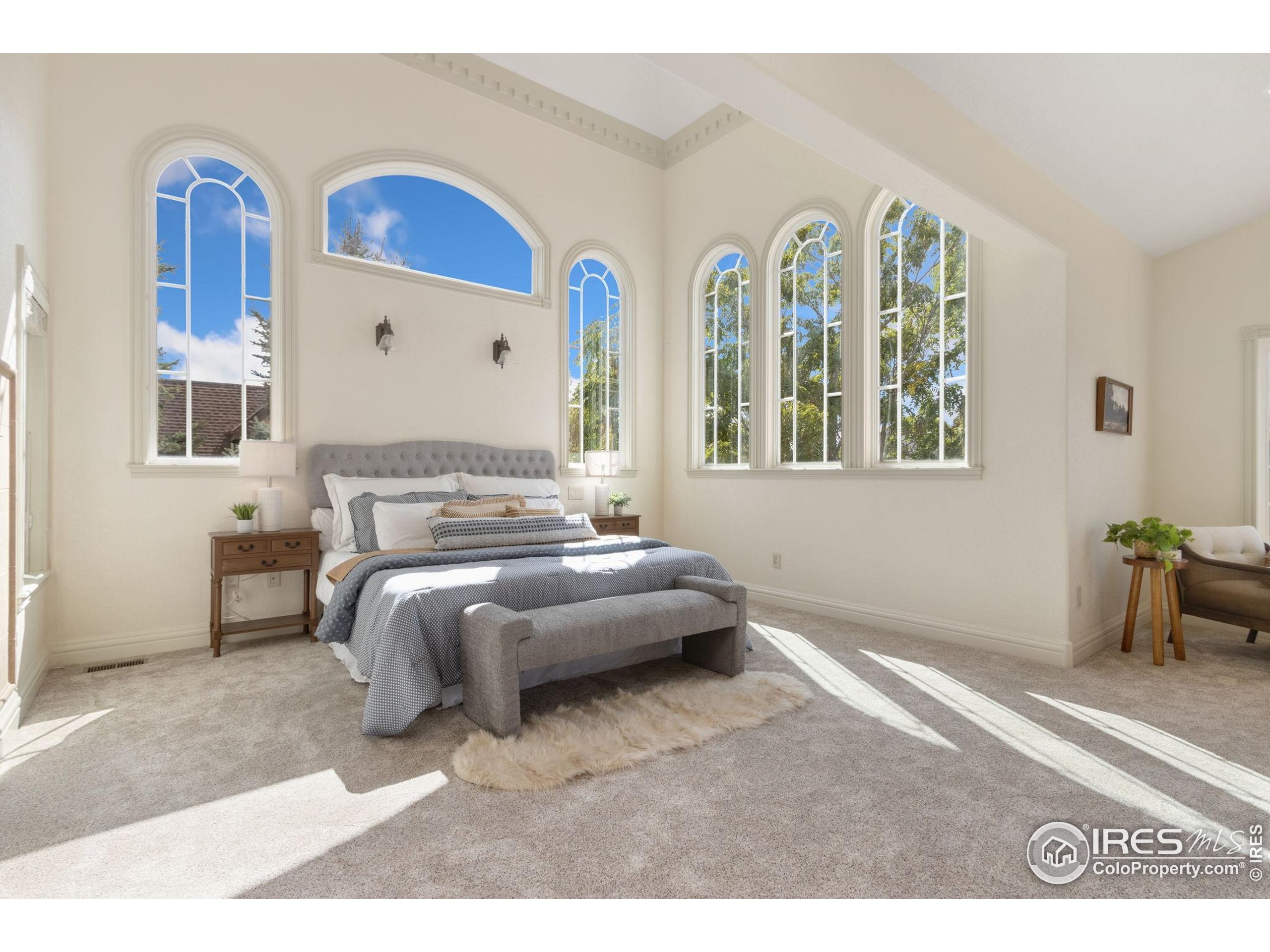 3908 Westfield Court Fort Collins, CO 80526 - Photo 18 of 45 a spacious bedroom with a bed and a painting on the wall