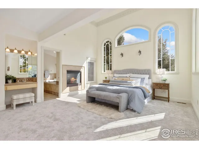 a spacious bedroom with a bed and a large mirror