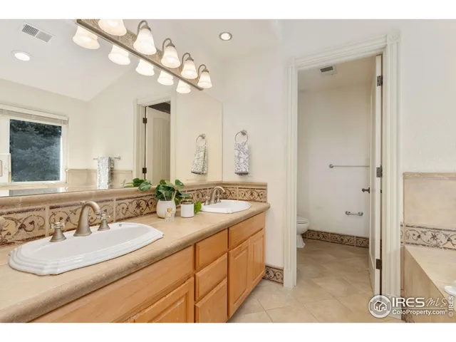 a bathroom with a sink a vanity a mirror and a shower