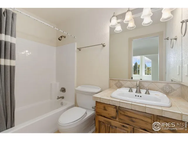 a bathroom with a sink toilet tub and shower