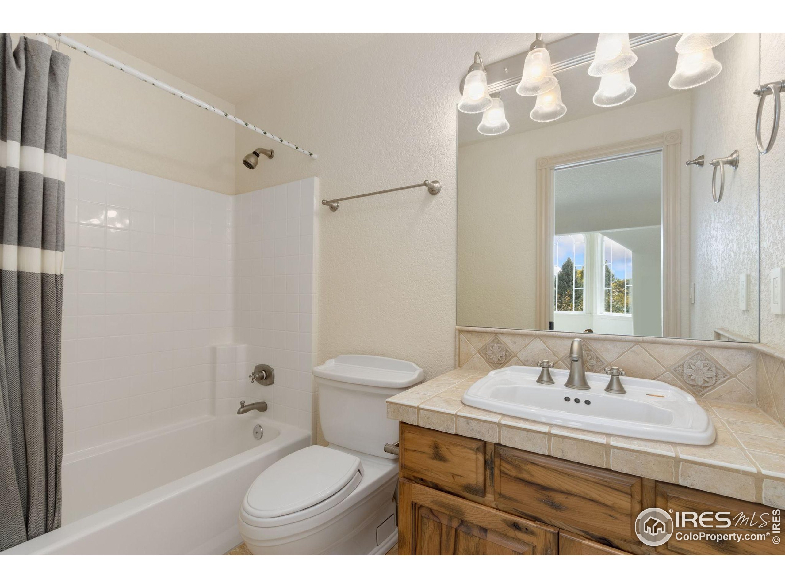 3908 Westfield Court Fort Collins, CO 80526 - Photo 26 of 45 a bathroom with a sink toilet tub and shower
