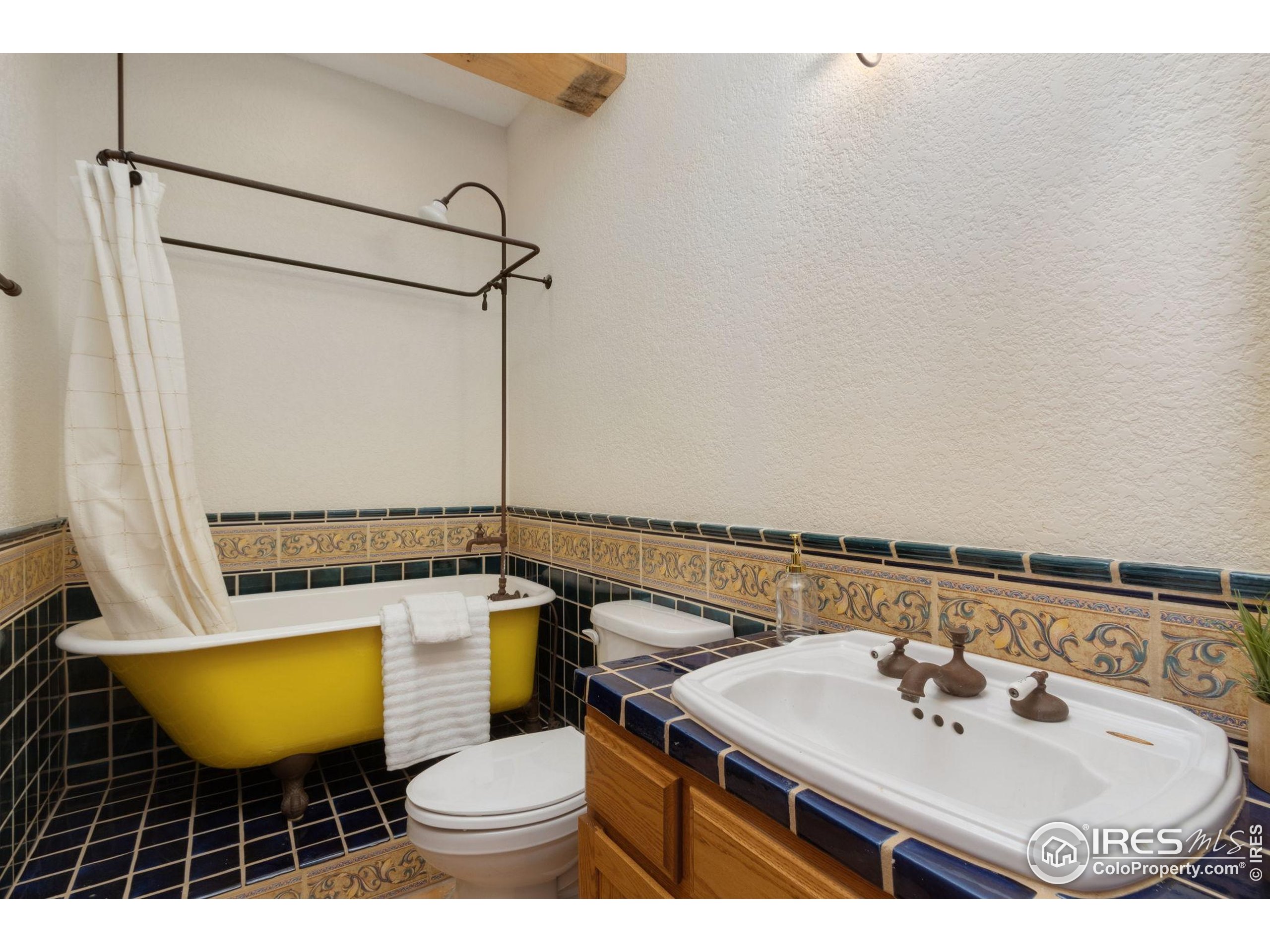 3908 Westfield Court Fort Collins, CO 80526 - Photo 7 of 45 a bathroom with a sink a mirror a toilet and a shower