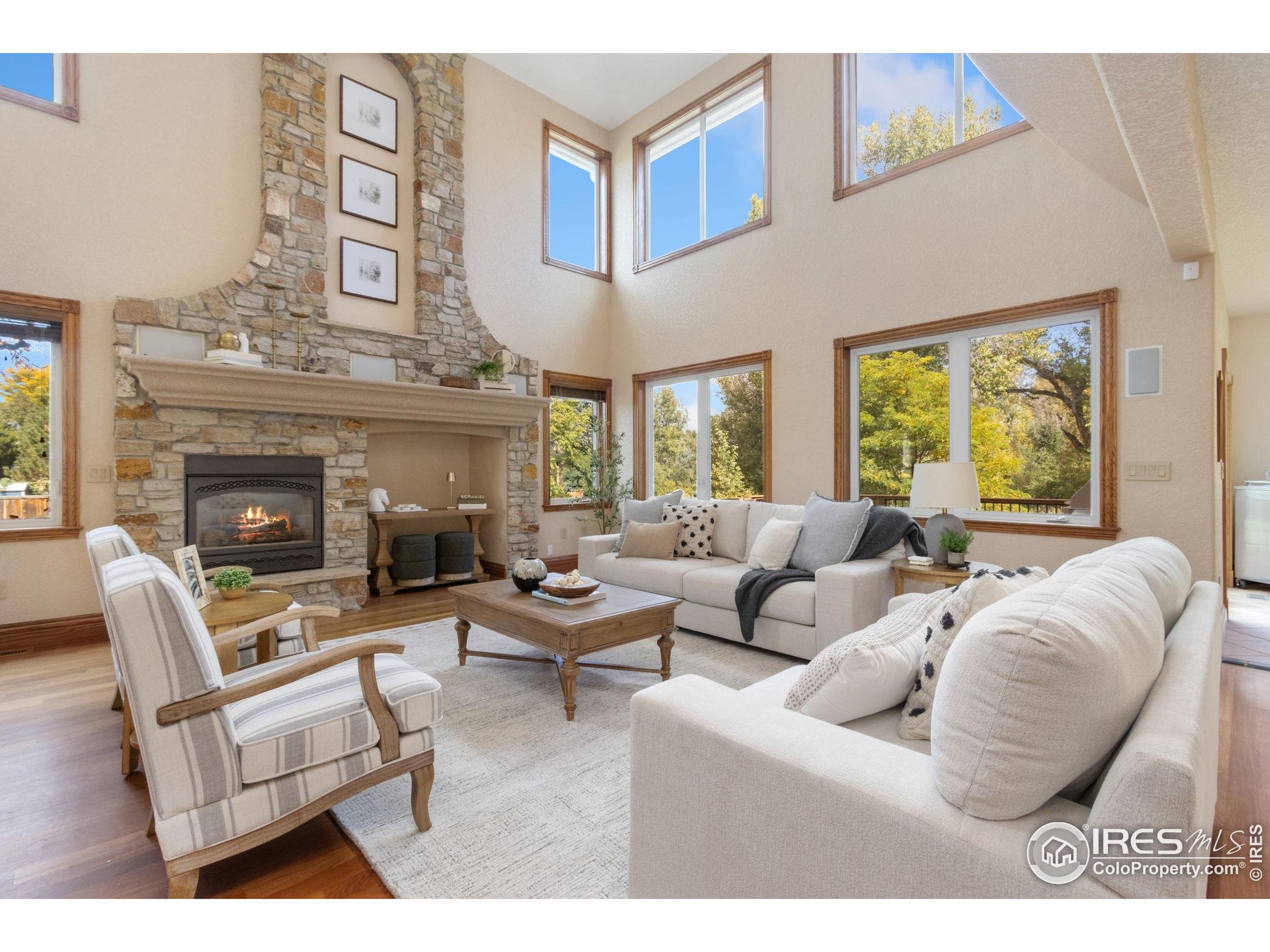 3908 Westfield Court Fort Collins, CO 80526 - Photo 8 of 45 a living room with furniture a fireplace and a large window