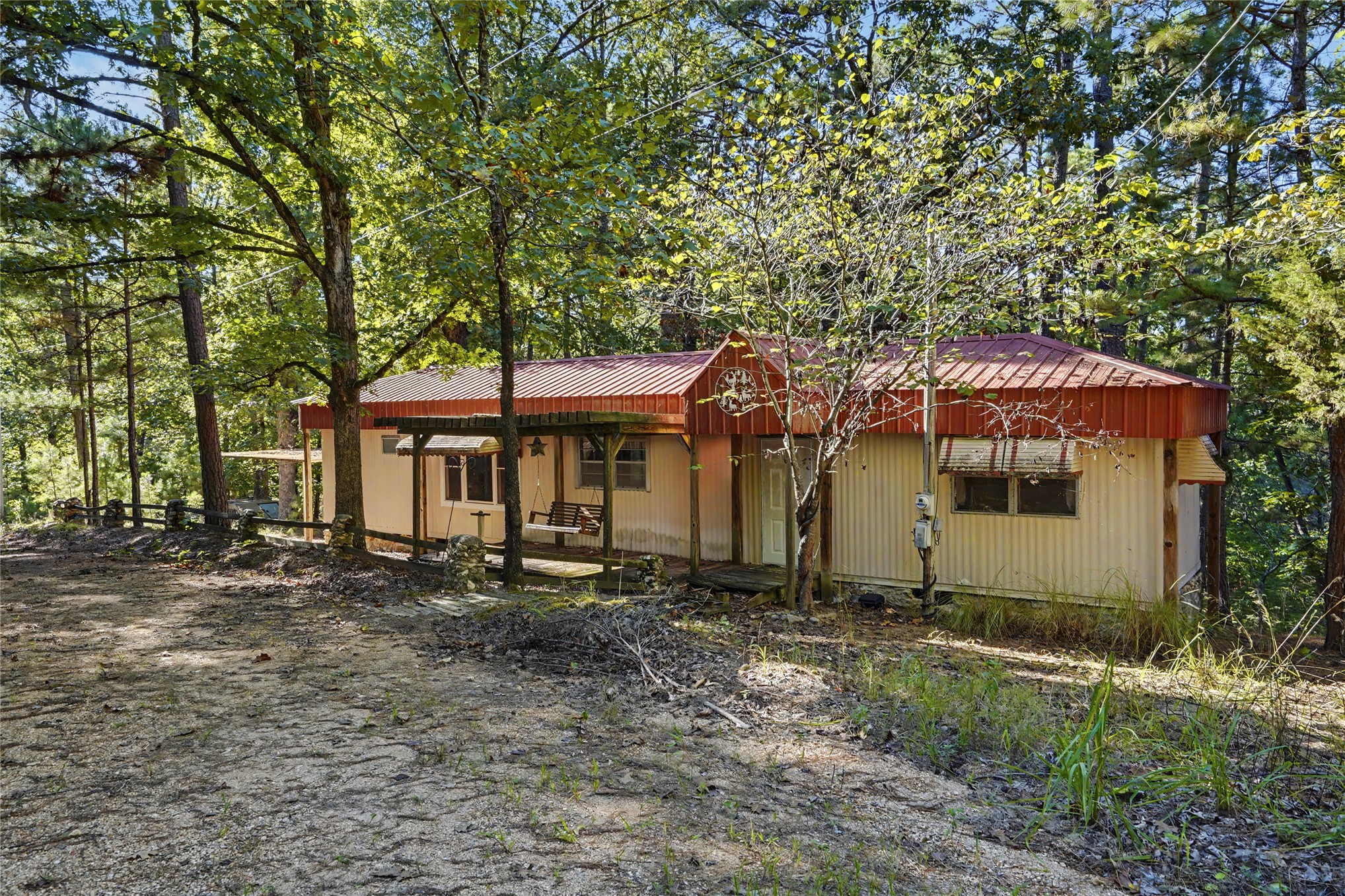 46420 South 590 Road Jay, OK 74346 - Photo 30 of 63 Wooded surroundings with a single-story structure featuring a red metal roof