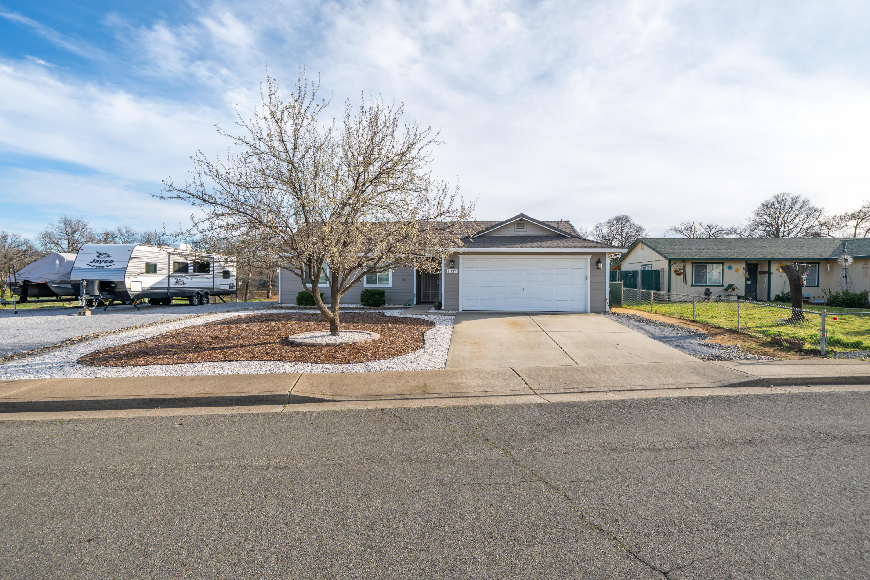 1837 Stetson Way Redding, CA 96003 - Photo 1 of 3 a view of a house with a swimming pool and a yard