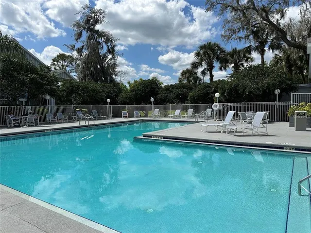 a aerial view of a house with swimming pool having outdoor seating