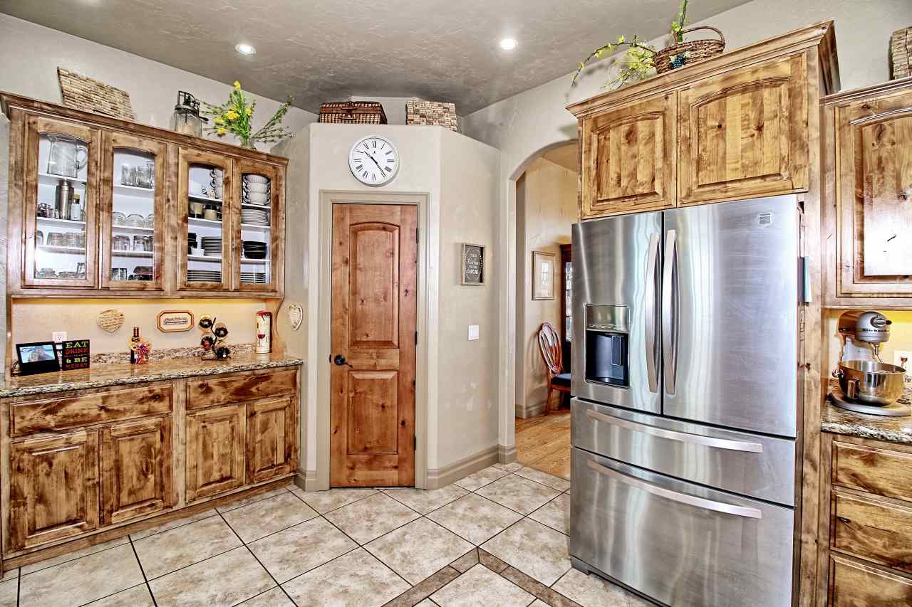 2029 K Road Fruita, CO 81521 - Photo 11 of 39 a kitchen with stainless steel appliances granite countertop a refrigerator and a stove top oven