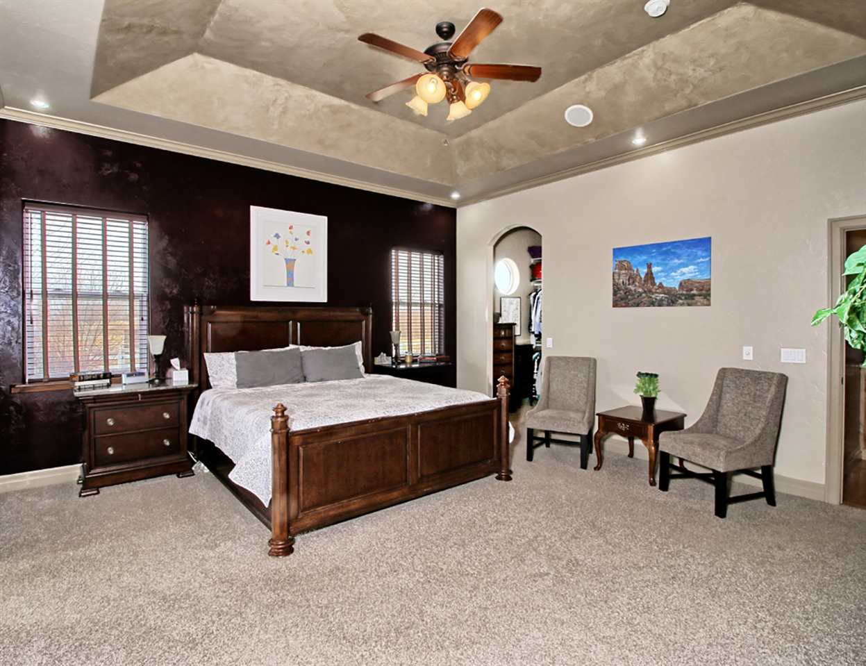 2029 K Road Fruita, CO 81521 - Photo 18 of 39 a spacious bedroom with a bed and a chandelier