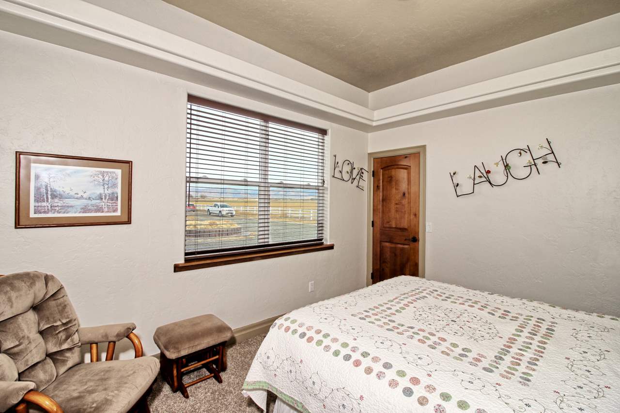 2029 K Road Fruita, CO 81521 - Photo 29 of 39 a bedroom with a bed and a window