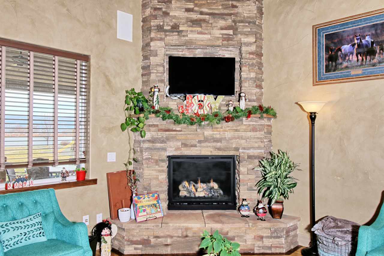 2029 K Road Fruita, CO 81521 - Photo 8 of 39 a living room with furniture a flat screen tv and a fireplace