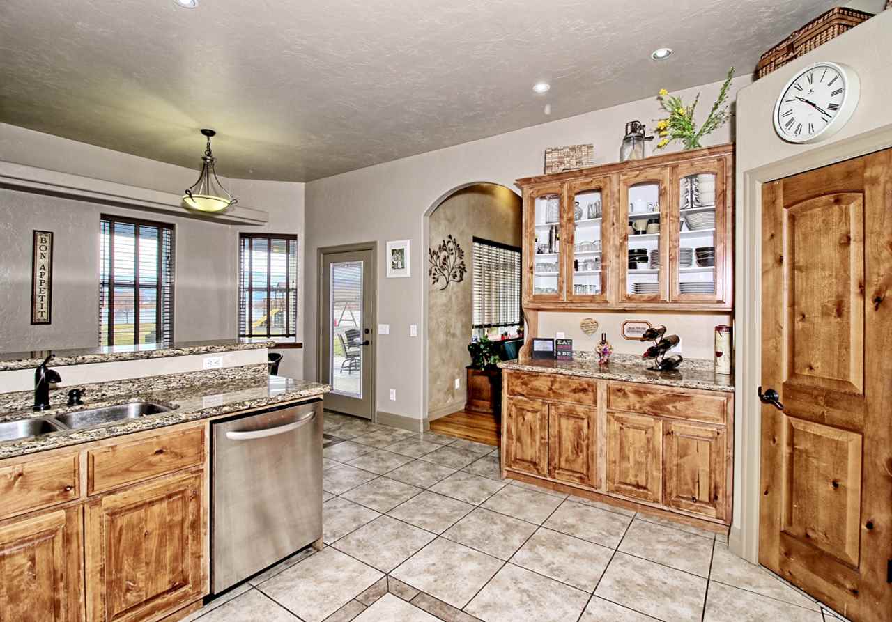 2029 K Road Fruita, CO 81521 - Photo 10 of 39 a large kitchen with stainless steel appliances granite countertop a stove and a sink